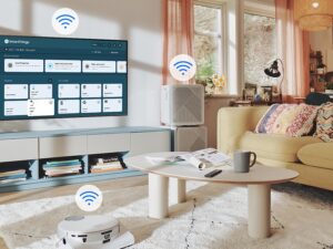 The SmartThings UI is on display on the QLED. WiFi icons are floating on top of the QLED, vacuum robot and air purifier.